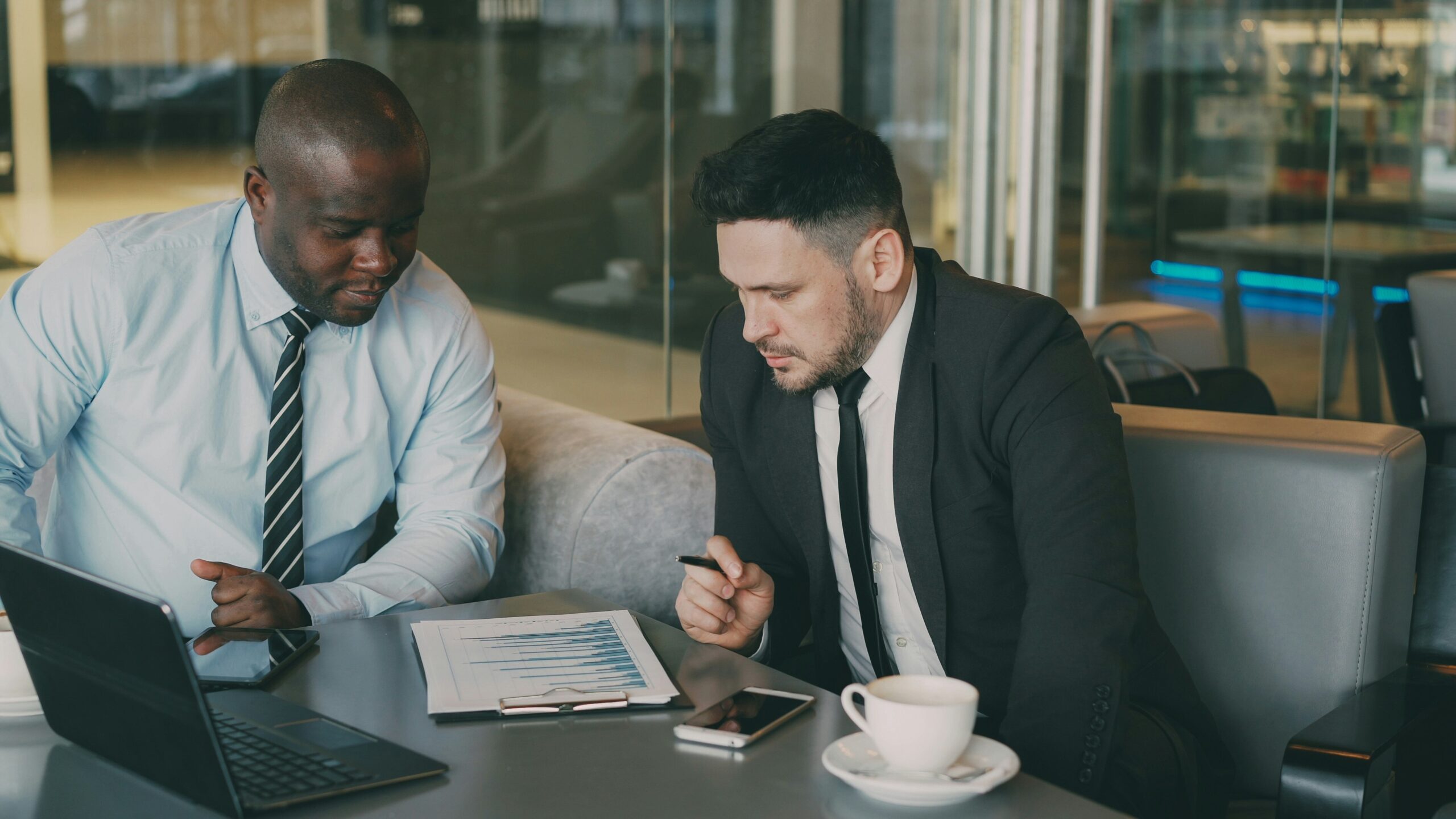 Two professionals reviewing documents at a table